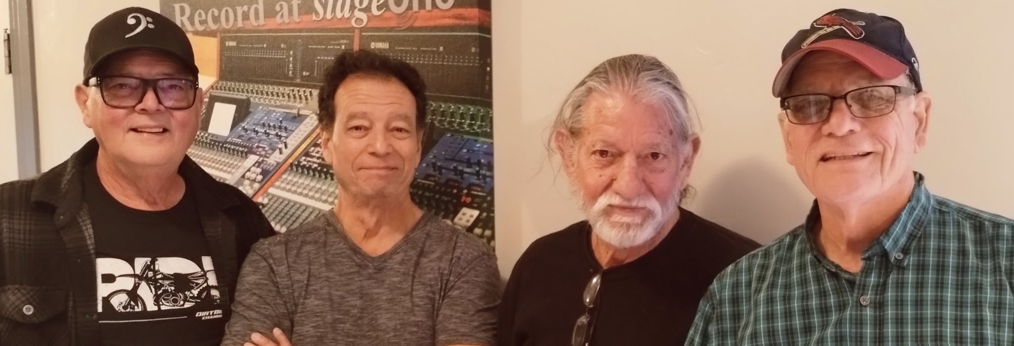 Four members of Fast & Loose standing side-by-side.